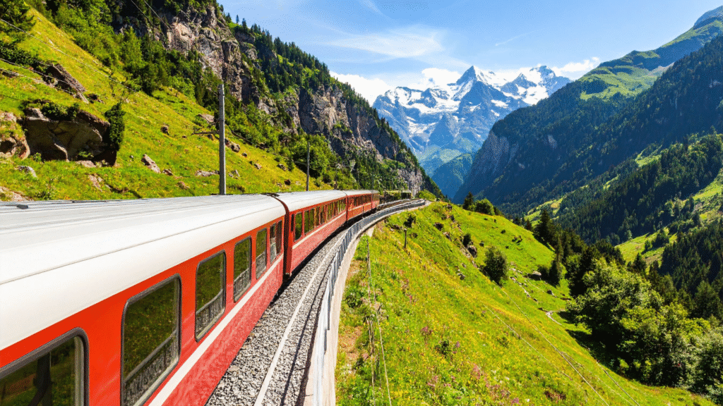 Daytime European train winding through mountain valleys—illustrating how to book European sleeper trains in 2025