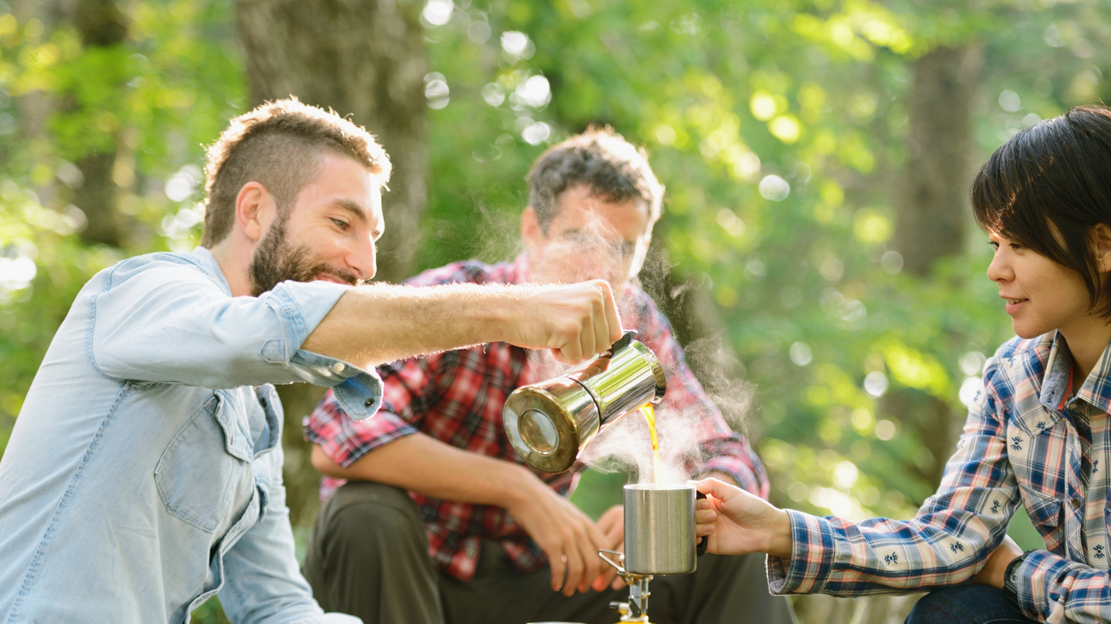 Local guide and traveler sharing morning coffee in forest — sustainable tourism connection 2025