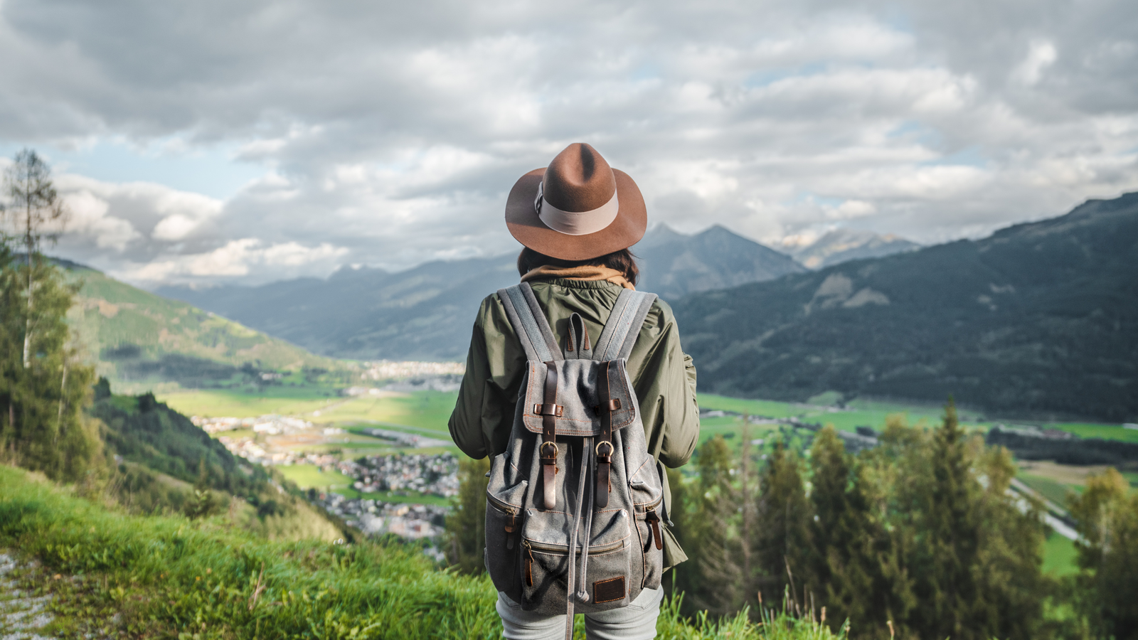Sustainable travel gear with refillable bottles, light luggage, and eco packing essentials