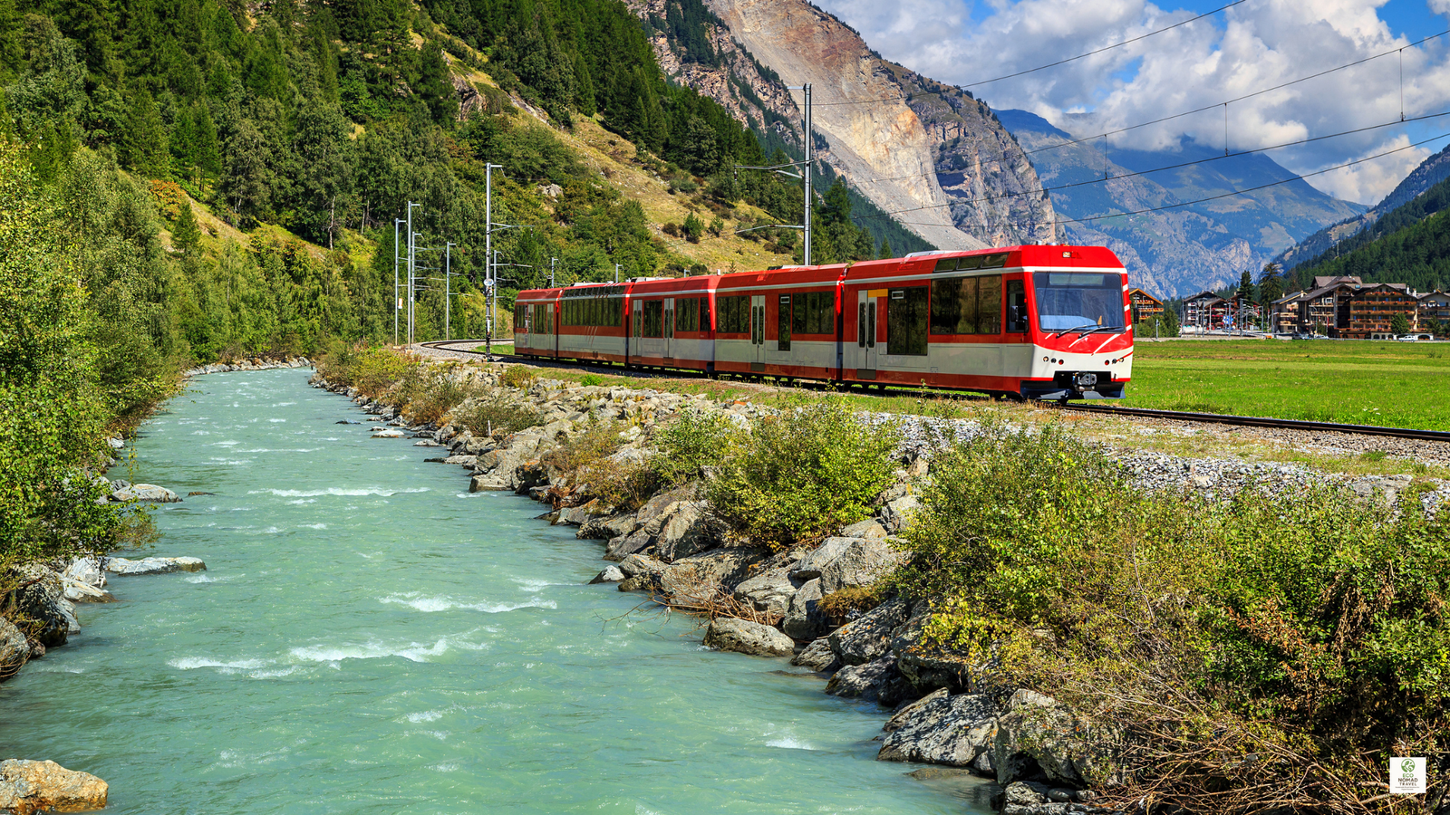Electric train traveling through a forest landscape, showing low-emission transport for carbon-neutral travel in 2025.