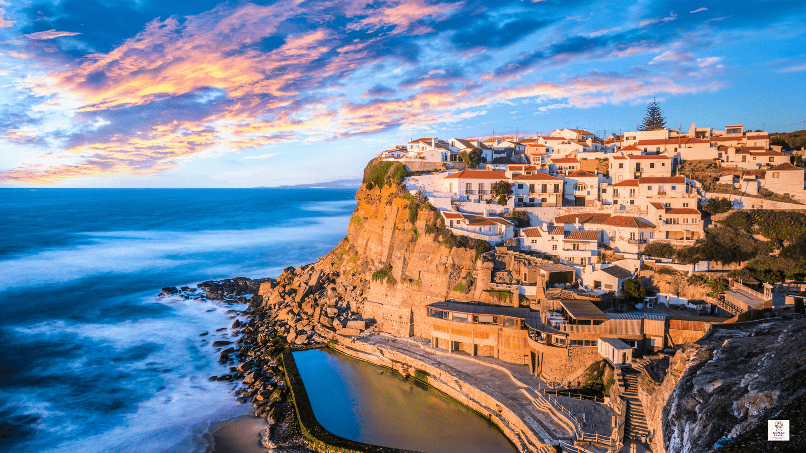 Clifftop view of Azenhas do Mar near Lisbon, Portugal, showing white houses above the Atlantic on a rail-first, flight-free travel itinerary in 2025