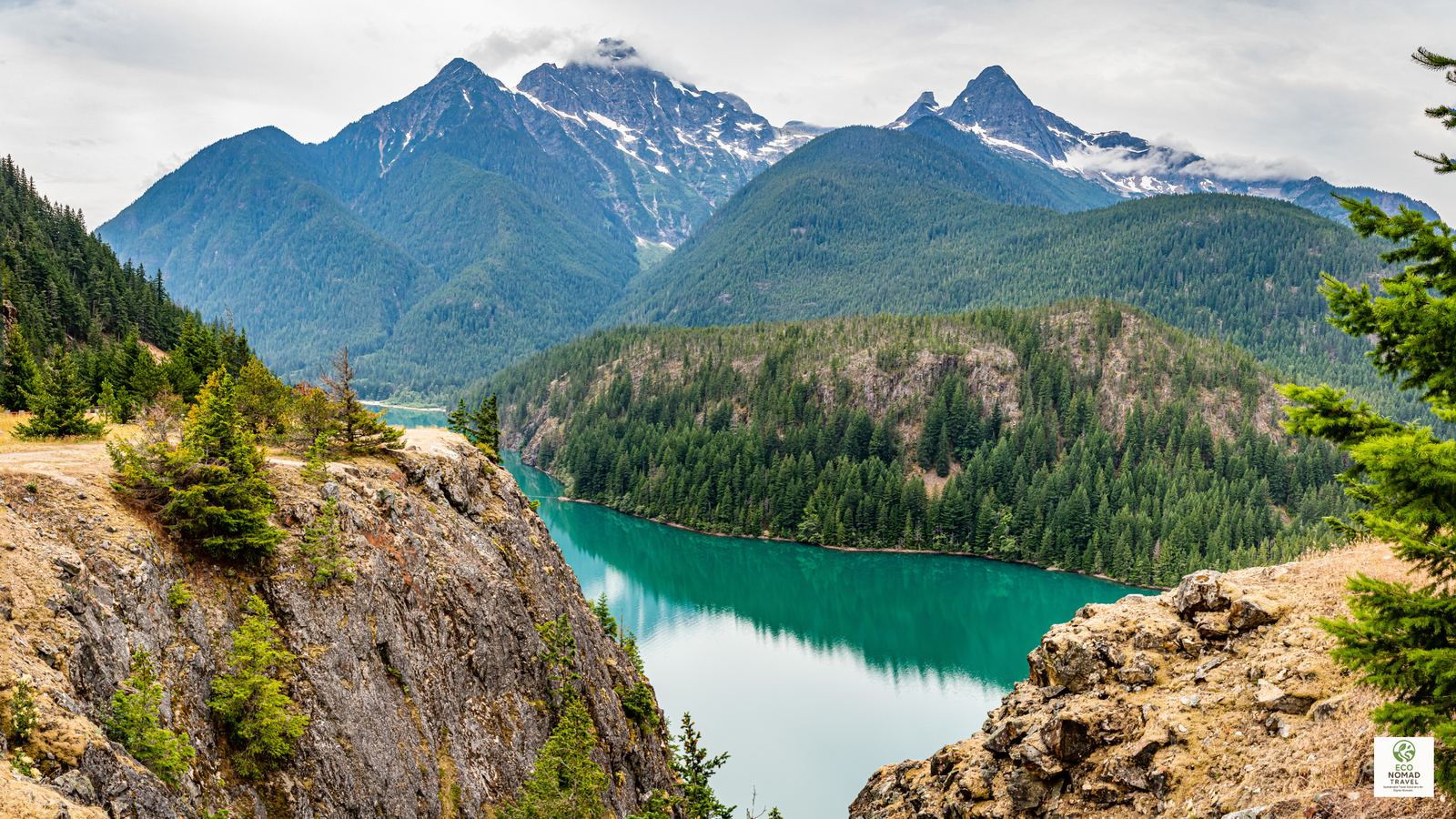 Mountain peaks, forests, and turquoise lake in North Cascades National Park, Washington, highlighting a wild stop on a low-flight national park road trip itinerary in 2025