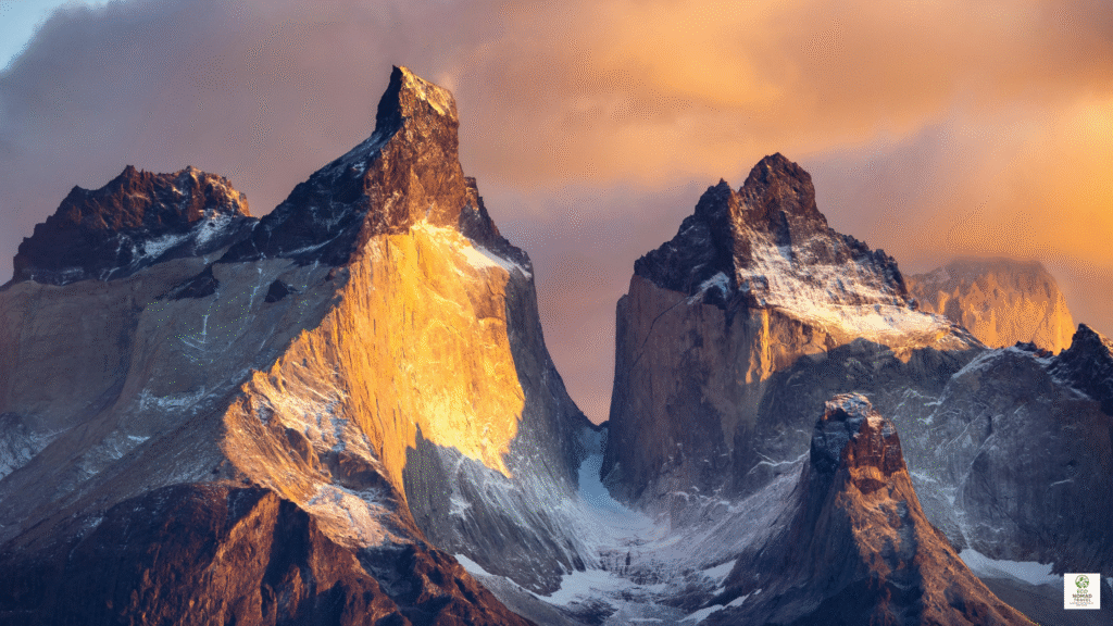 Sunrise over rugged Patagonia mountains with a remote eco lodge in the valley, ideal for off-grid stays in 2025