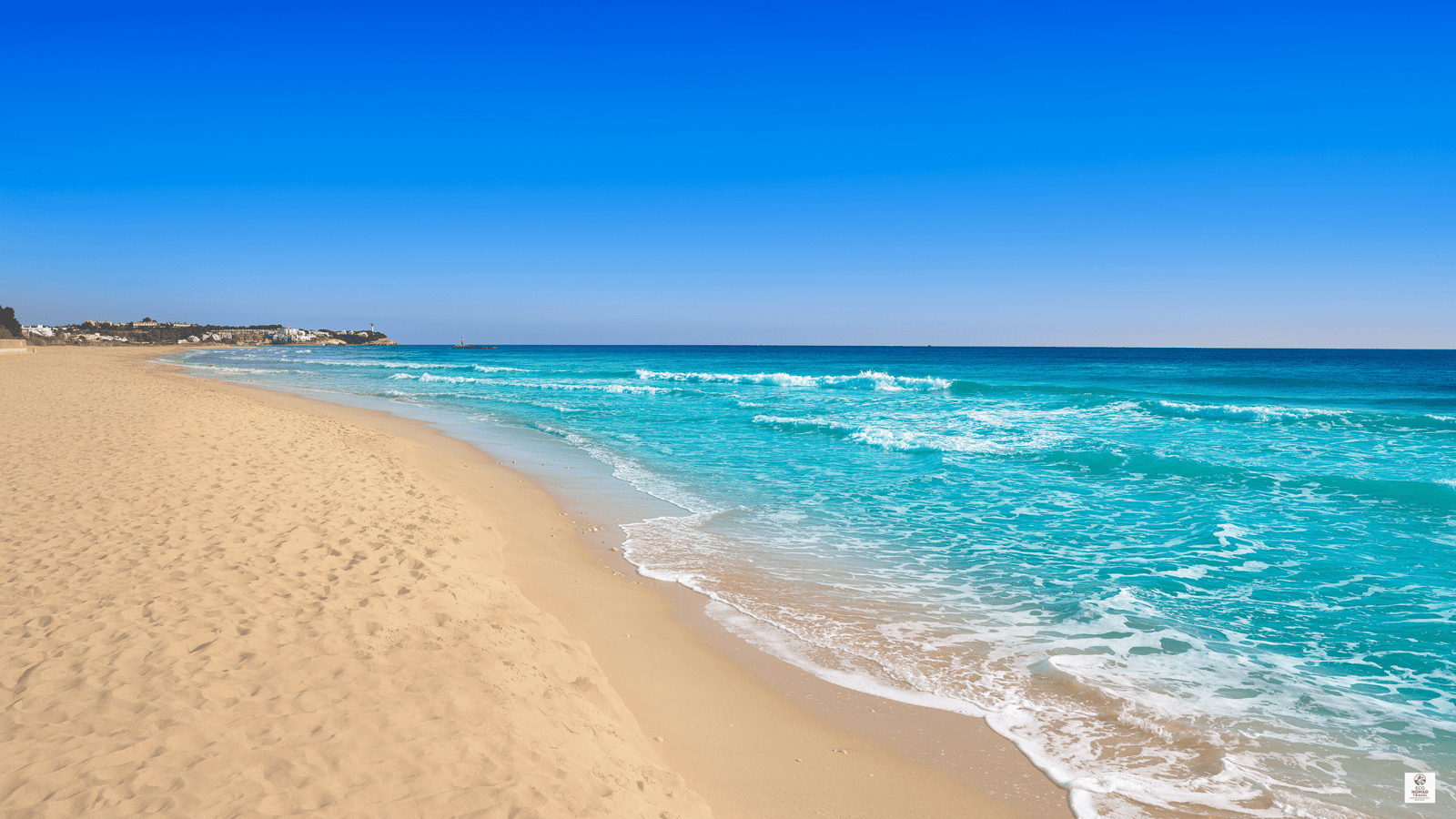 Sandy beach on the Adriatic coastline with gentle waves and open shoreline