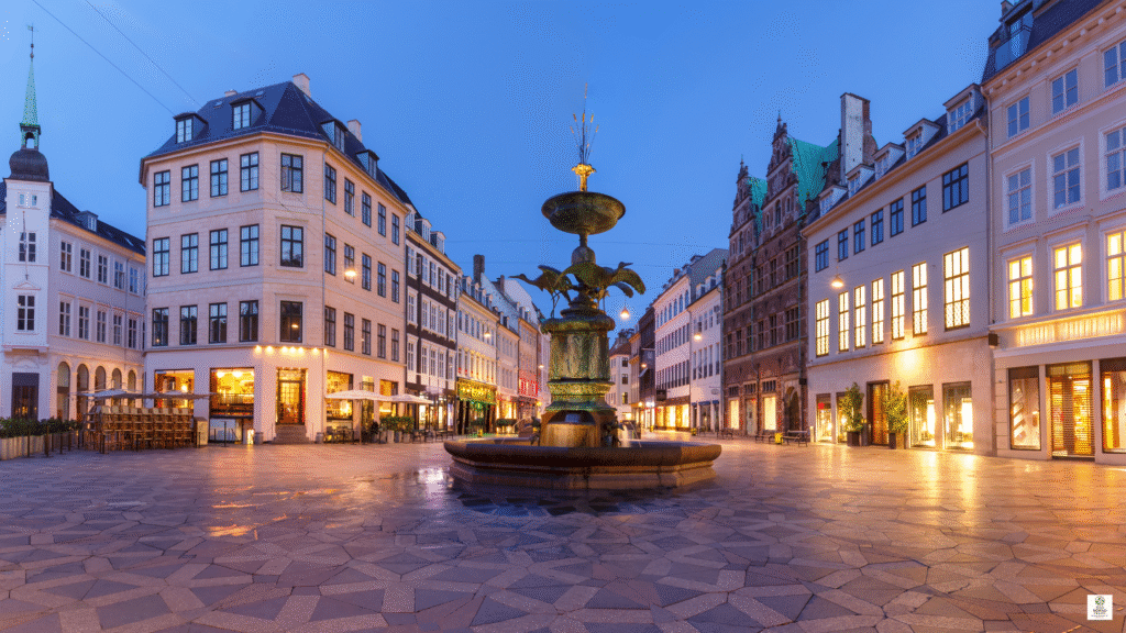 Pedestrian-only Stroget street in Copenhagen, Denmark with cyclists, shops, and historic buildings showing sustainable tourism in a walkable city center
