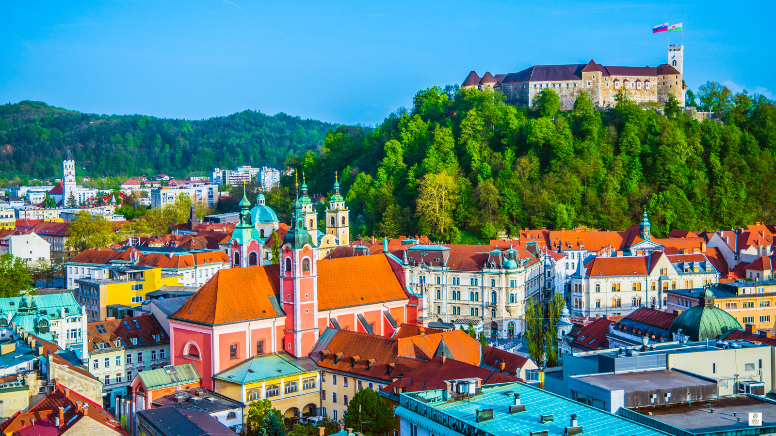 Ljubljana riverfront with car-free streets, cafés, and walkers along the Ljubljanica River