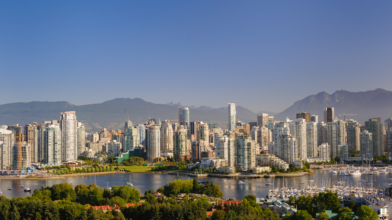 Vancouver Canada BC with trees, ocean, and city skyline in the background