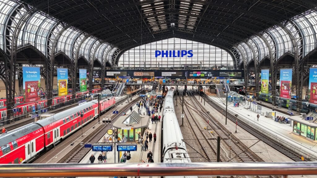 German station concourse image used as the featured image for a train travel in Germany guide.