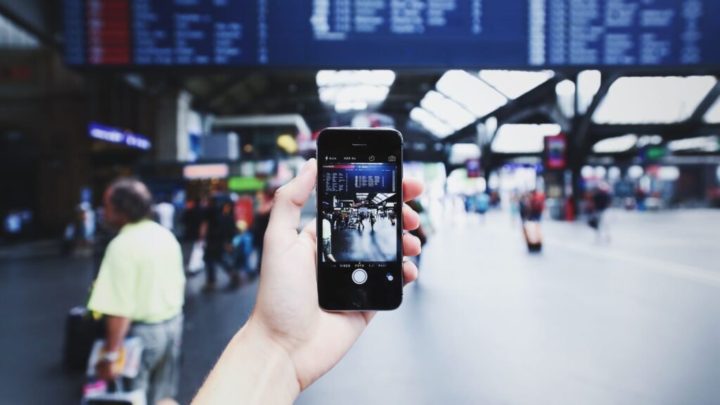 A traveler booking a European train ticket on a smartphone before a rail journey.