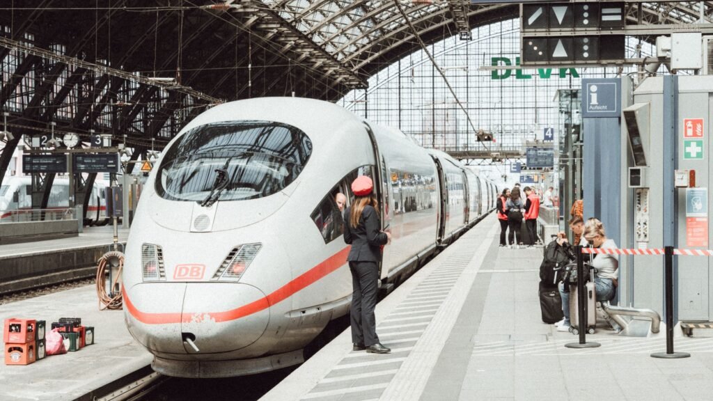 Passengers boarding a high-speed train at a modern German railway station. Photo by Masood Aslami via Pexels.