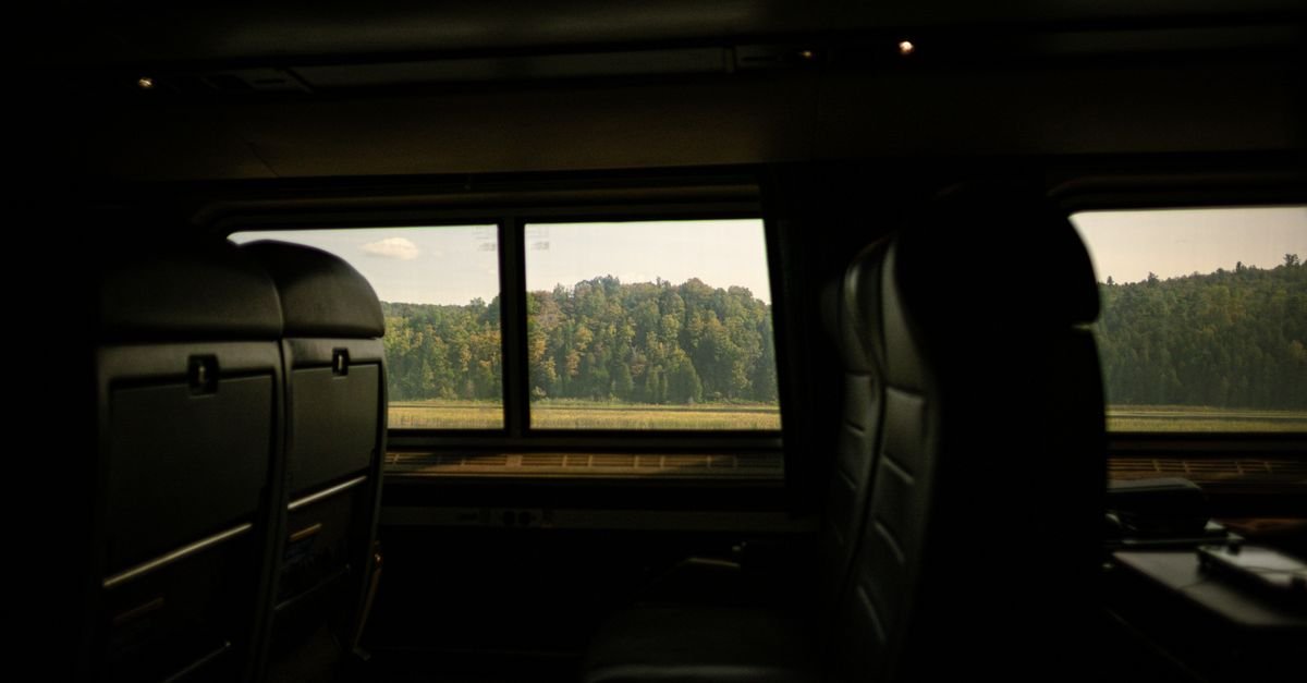 A scenic view from inside a train observation car