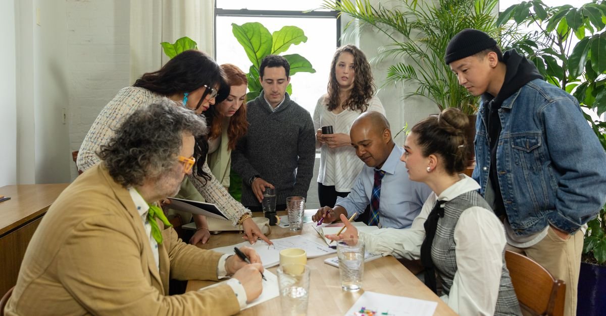 People working at a long shared table