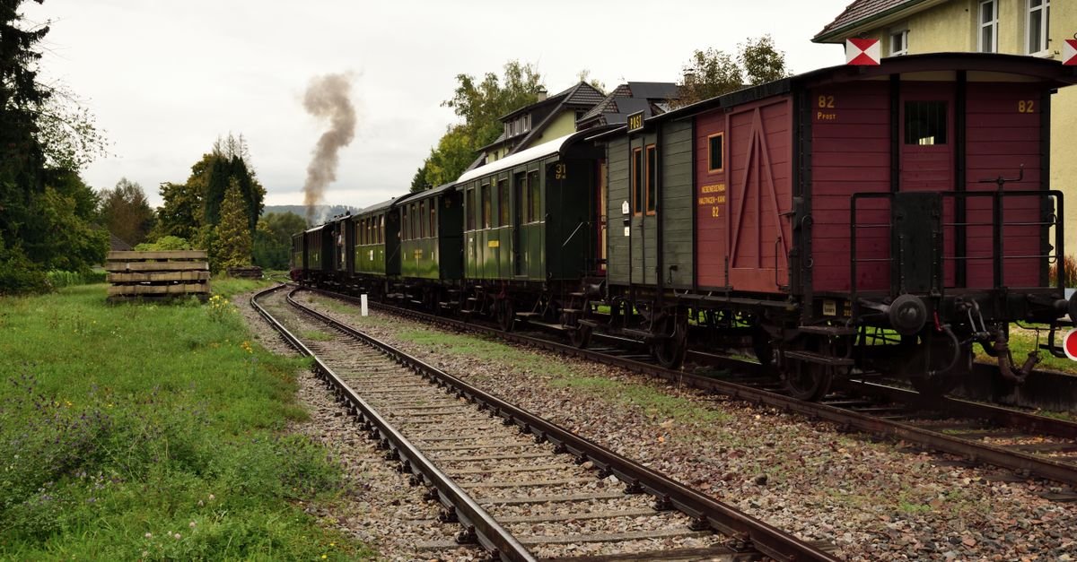 A regional train crossing open green countryside