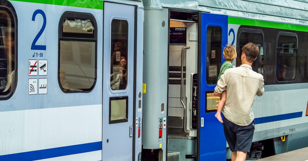 A family boarding a train together on a platform