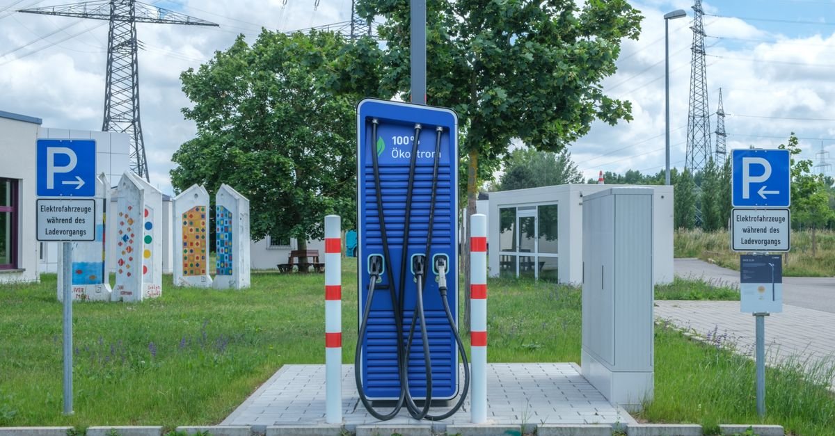 An electric car charging at a motorway charging station