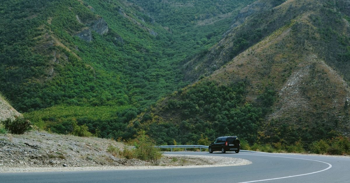 A car on a winding scenic mountain road